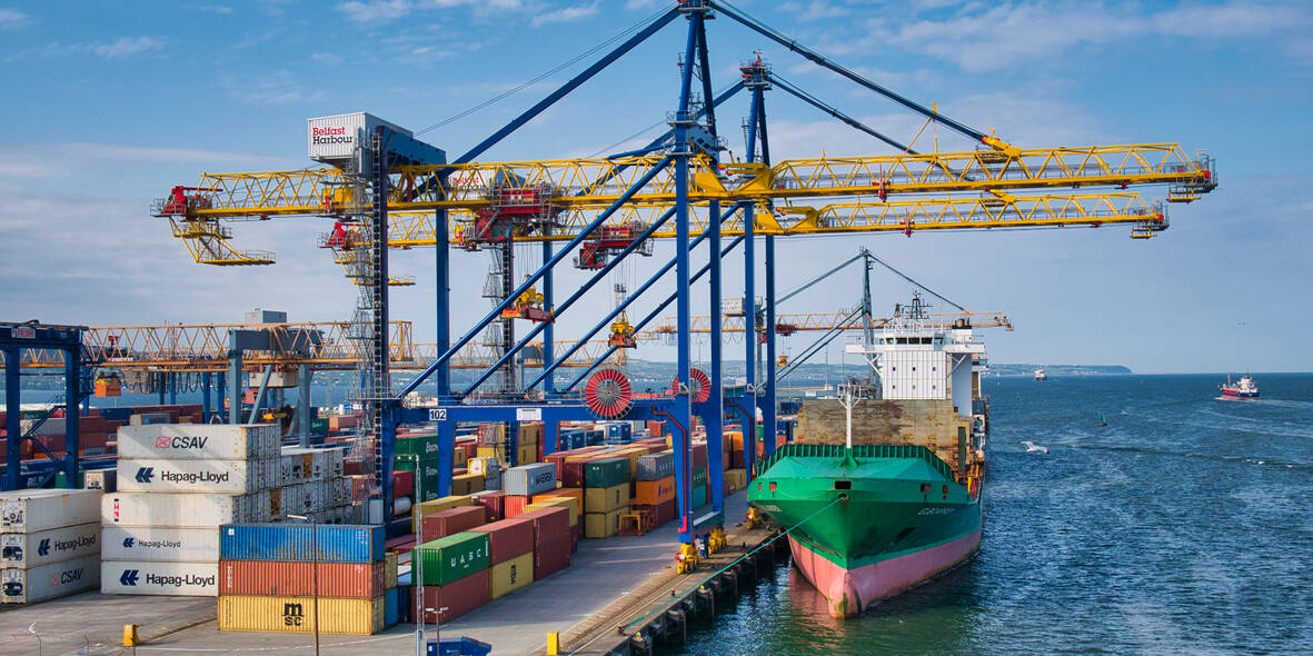 Container ships loading and unloading at the Belfast Harbour container terminal on a sunny evening in June 2021
