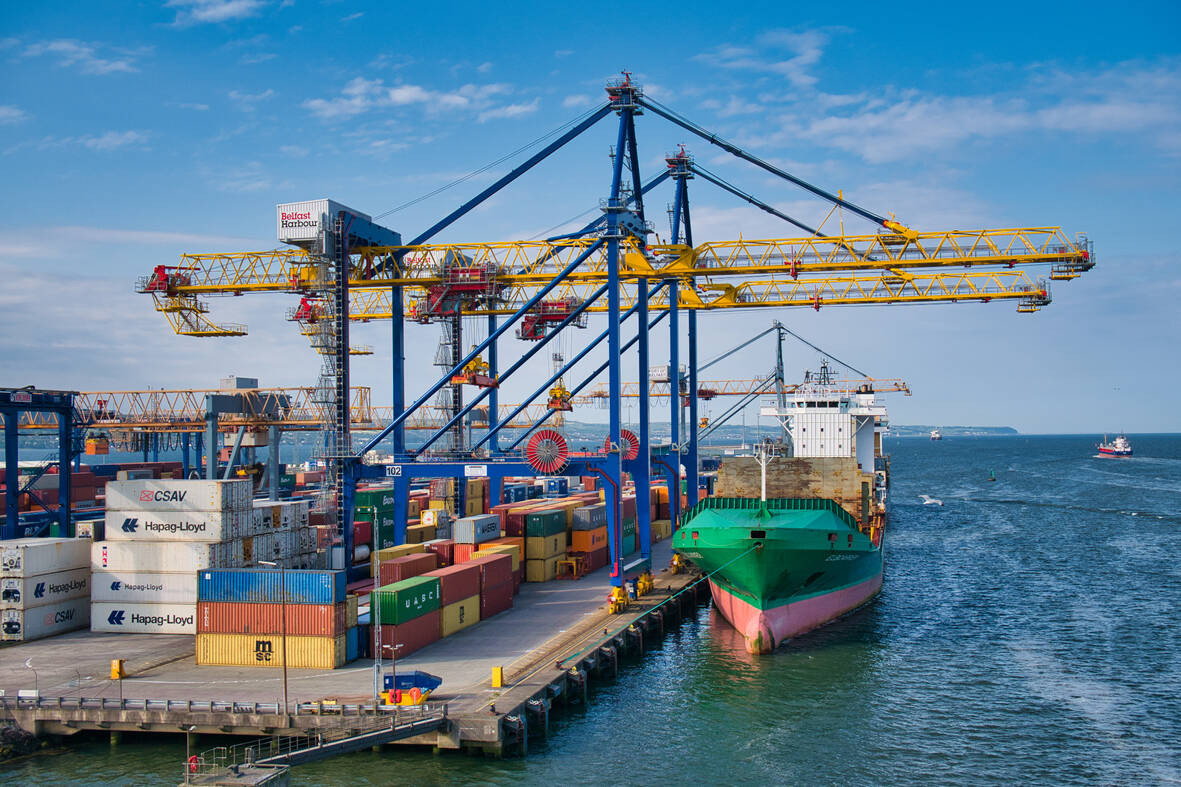 Container ships loading and unloading at the Belfast Harbour container terminal on a sunny evening in June 2021