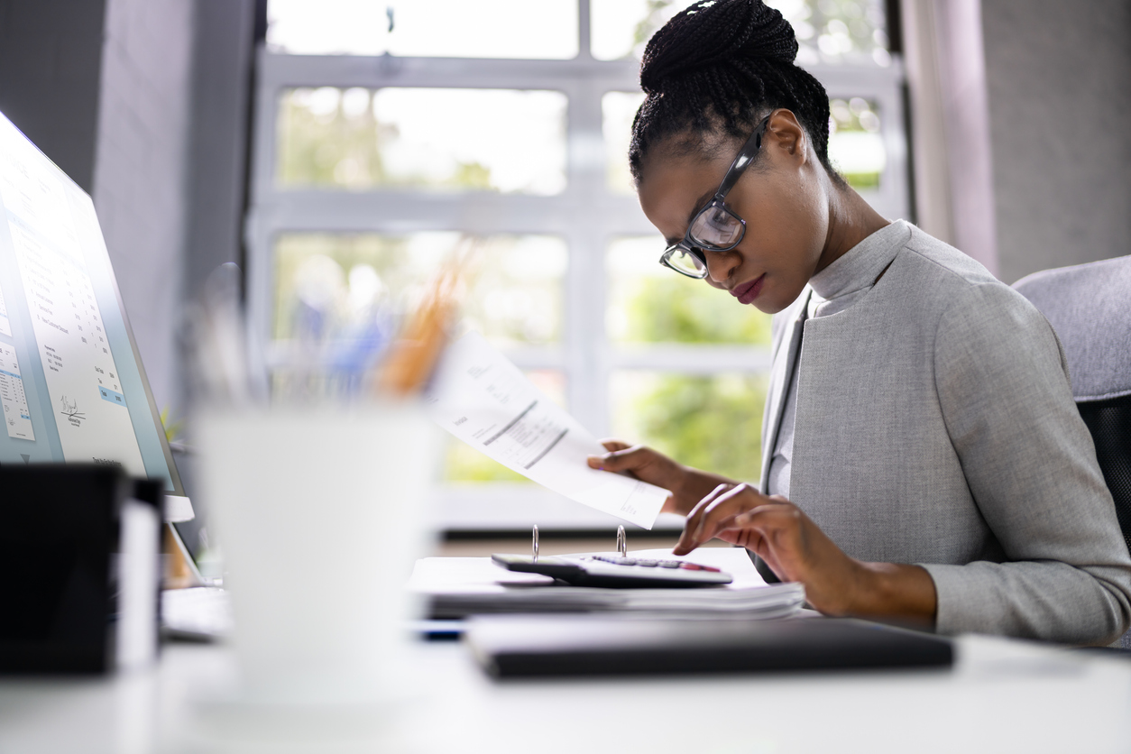 African American Accountant Or Auditor With Calculator