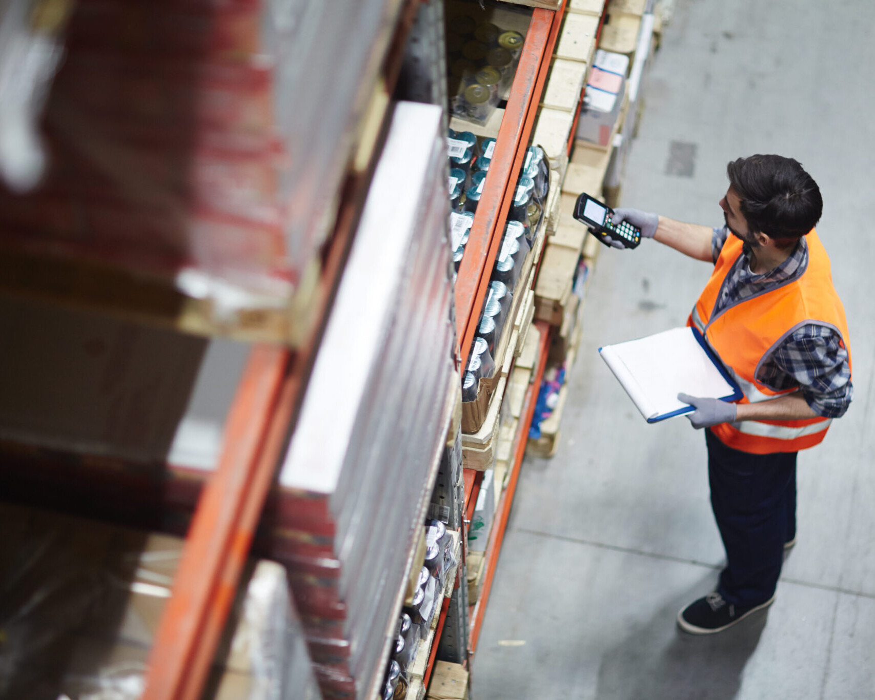 An image of a man checking goods in a warehouse