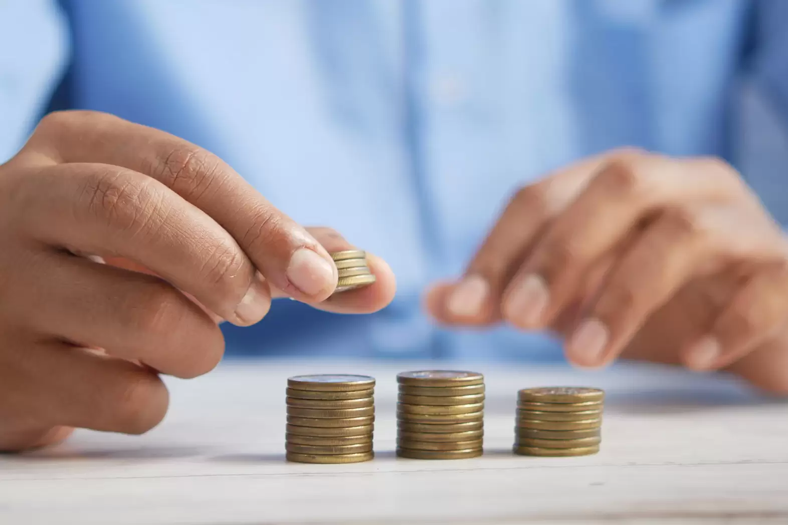 An image of a man stacking coins