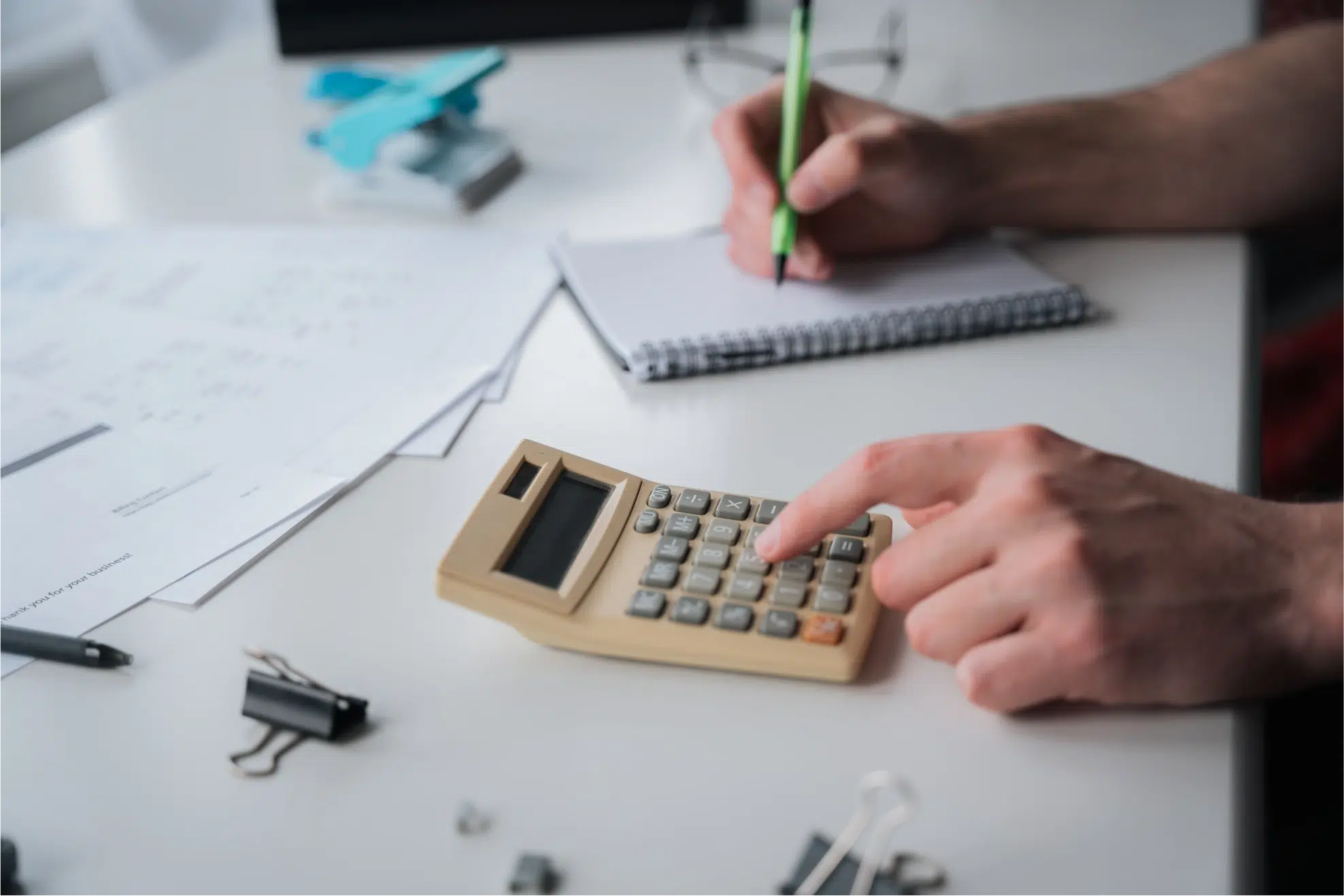 An image of someone performing calculations with a calculator