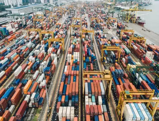 An image of an import dock with many containers.