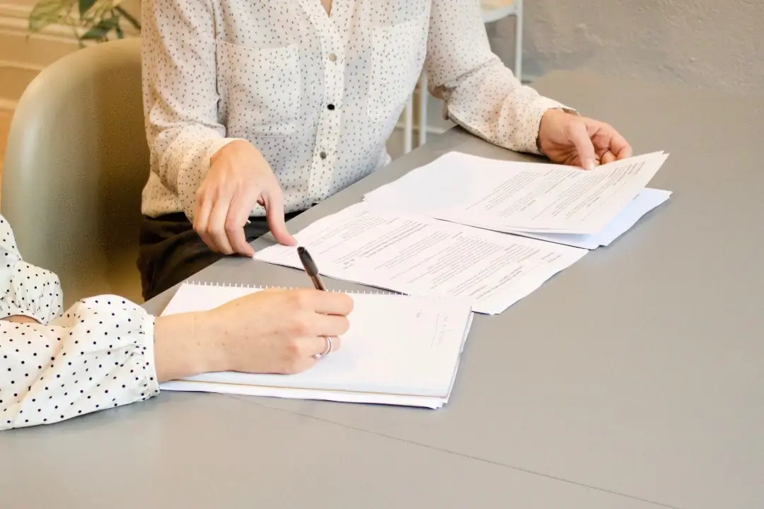 An image of two business people working on a project.