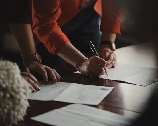 An image of two business people collaborating on work
