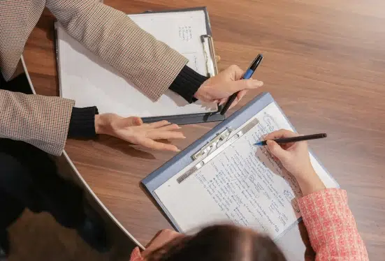 An image of two people collaborating on work