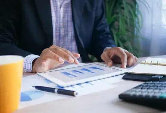 An image of someone looking through finance reports on a tablet