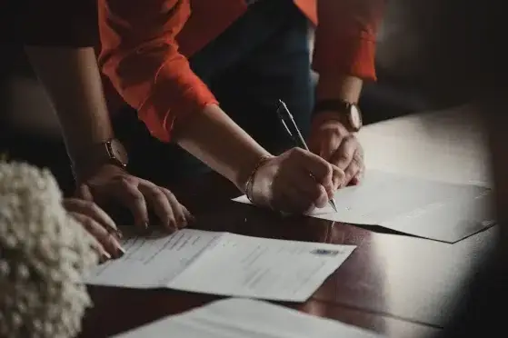 An image of people collaborating on paperwork regarding exporting.